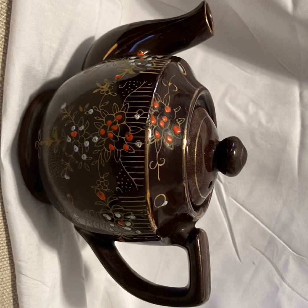 Like new , single size  4” mini ceramic like tea pot.  unique chocolate brown